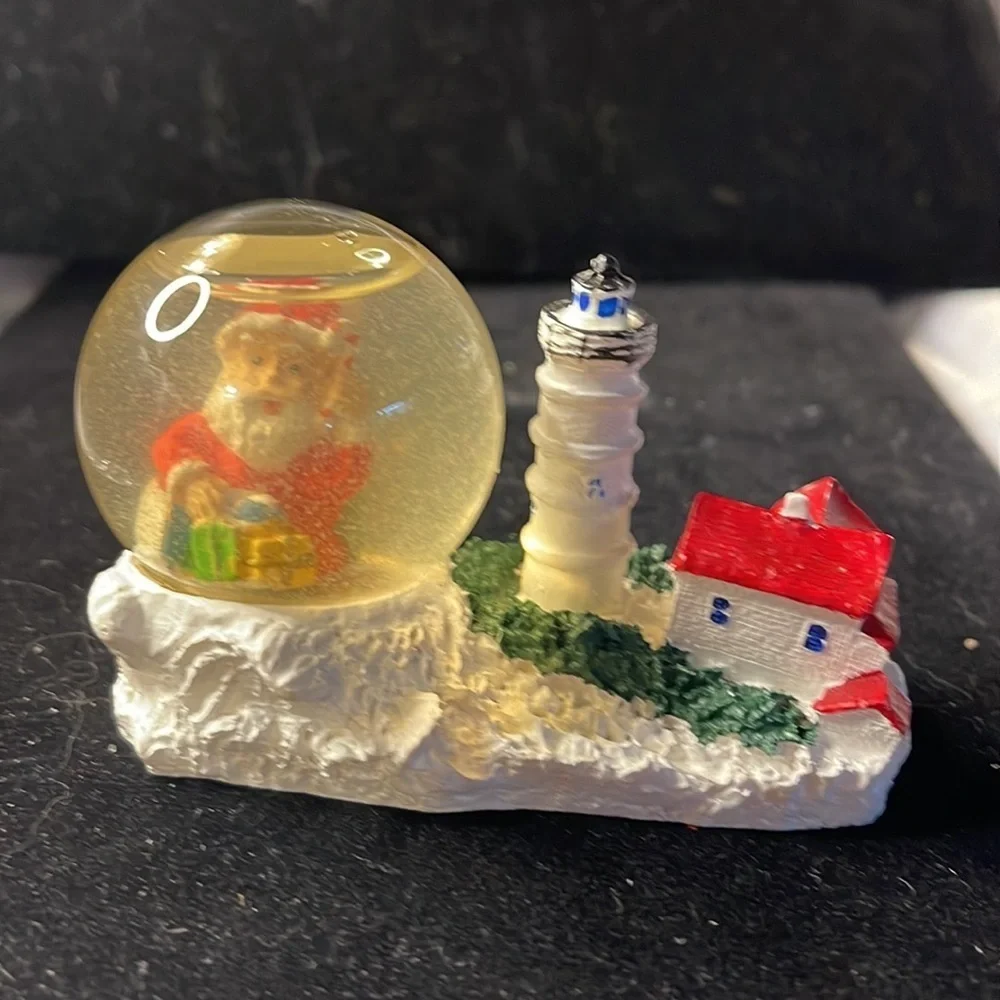 Small Snow Globe Lighthouse w/red roof house-color is clouded Santa is a floater